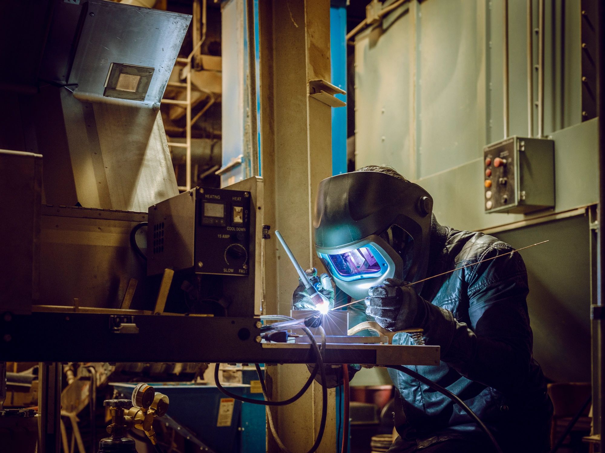 Steel fabricator welding in a workshop